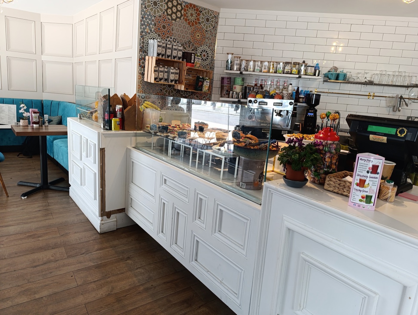 The bakery and coffee counter with pastries on display and an espresso machine.
